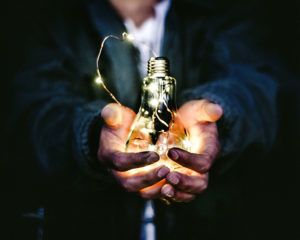 Photo of a man holding a lightbulb